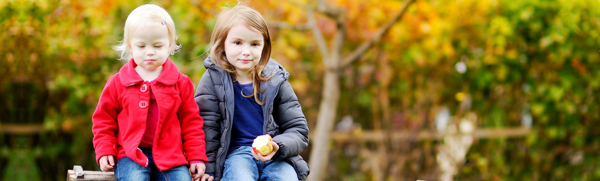 two children eating apple